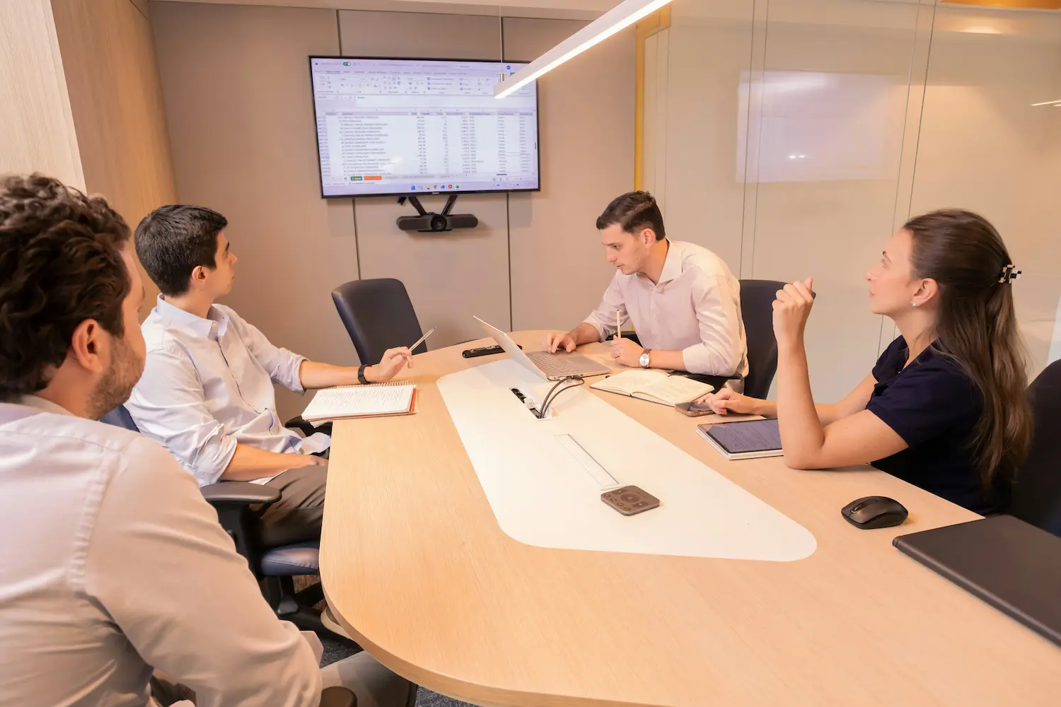 Colleagues discussing work around a meeting table