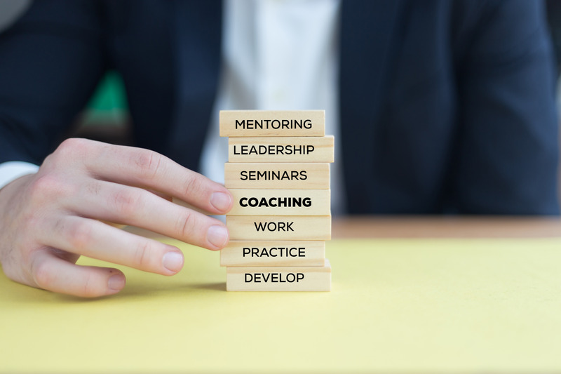 Coaching concept showing the connection between leadership and development